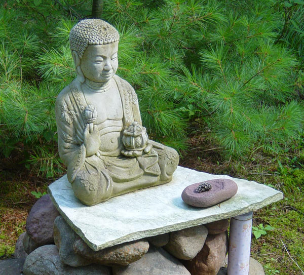 Walking partly down the hill and to the south is the Meditation Garden and Buddha statue. Pat appreciates the opportunity to sit and meditate.  The space is deep in the woods where birds and small animal sounds can be heard.